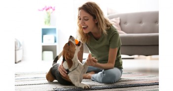New data confirms the strength of pet ownership in Europe Woman playing with her dog at home