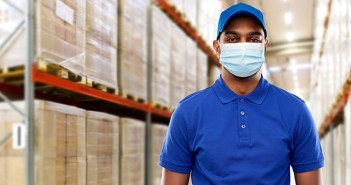 Protecting vulnerable workers during the COVID-19 outbreak indian delivery man in medical mask at warehouse